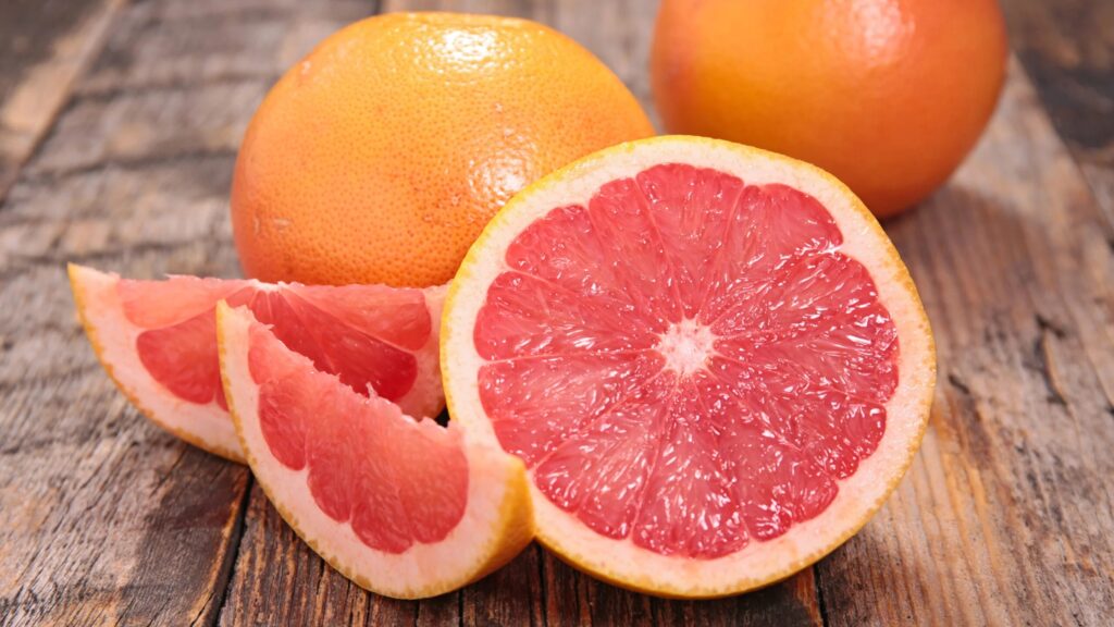 Pink grapefruit fruits, one cut open